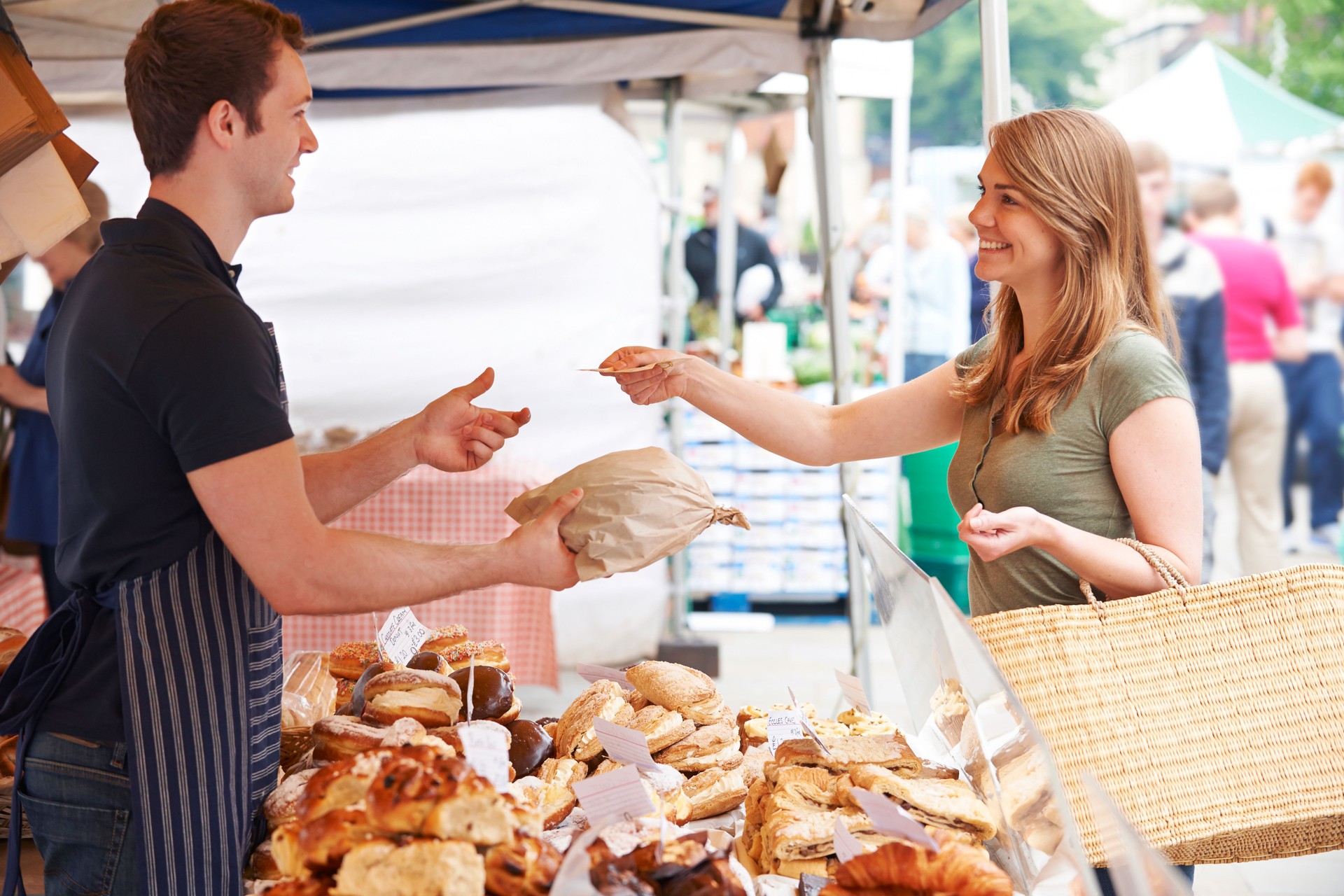 Woman Buying Bread From Market Stall